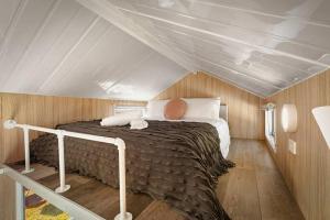 a bedroom with a bed in a attic at Bluestone Alpacas The Alpaca Deluxe by Tiny Away in Merbein