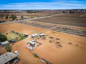 an aerial view of a farm with a dirt field at Bluestone Alpacas The Alpaca Deluxe by Tiny Away in Merbein