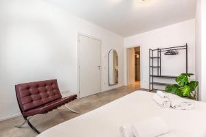 a bedroom with a large bed and a chair at Elegant Apartment with private parking in downtown Padua in Padova
