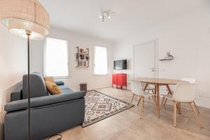 a living room with a blue couch and a table at Elegant Apartment with private parking in downtown Padua in Padova