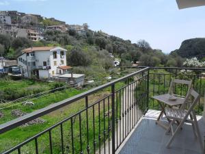 a balcony with a chair and a view of a city at B&B Da Rosa Camerota in Camerota