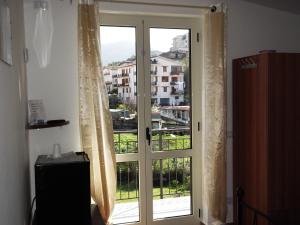 a door with a window with a view of a city at B&B Da Rosa Camerota in Camerota