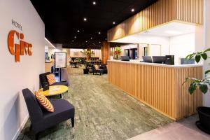 an office lobby with chairs and a reception desk at Hotel Give in Christchurch