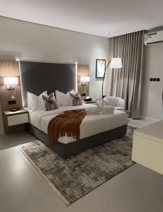 a bedroom with a large bed in a room at Marvin Suites in Al Wajh