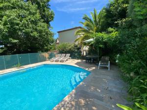 a swimming pool in the backyard of a house at VILLA BIARRITZ 1923 private pool in Biarritz