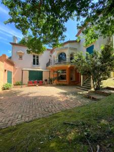an exterior view of a house with a patio at VILLA BIARRITZ 1923 private pool in Biarritz
