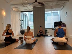 a group of women sitting in a yoga class at The Pacific House in Sydney