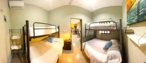 a room with two bunk beds and a mirror at Casa Rio Lagartos in Río Lagartos