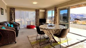 a living room with a table and chairs at Askray Apartment - Lake Tekapo in Lake Tekapo