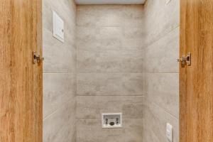 a bathroom with a shower with a stone wall at Premium Loft in Bogota in Bogotá