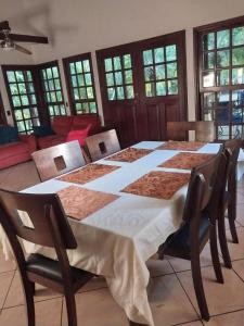 a large dining room table with chairs and a tableablish at Casa Tranquilo in Chinandega +11 photos