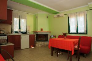 a kitchen with a table with a red table cloth at To Asteri in Avgonyma