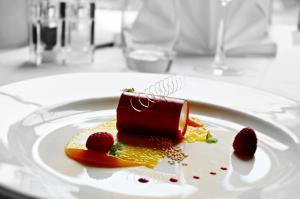 a dessert on a white plate on a table at Heritage Grange at Thurston, Hotel in Bury Saint Edmunds