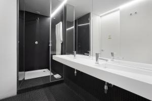 a bathroom with two sinks and a mirror at LSA Ascensor da Bica by Numa in Lisbon