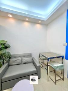 a living room with a couch and a table at Direct to pool unit Shore Residences Condominium MOA Complex in Manila
