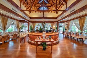 a restaurant with tables and chairs and a bar at Sokha Angkor Resort in Siem Reap +41 photos
