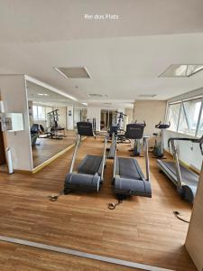 a gym with treadmills and ellipticals in a building at Brookfield Towers - Jardim Goiás By Rei dos Flats in Goiânia