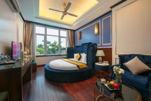 a hotel room with a bed and a couch at Royal Hotel & Spa Bắc Ninh in Ðồng Ky +21 photos