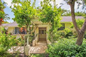 a yellow house with trees in front of it at Coral Gables home in Saint James