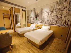 two beds in a hotel room with a drawing on the wall at City Comfort Inn Yangjiang High-tech Zone Pinggang in Yangjiang +172 photos