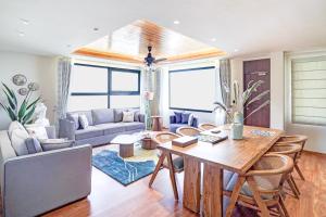 a living room with a table and a couch at Sunday Premium 5 BHK Villa Mihika, Shimla in Shimla