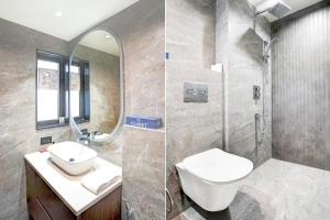 a bathroom with a toilet and a sink and a shower at Sunday Premium 5 BHK Villa Mihika, Shimla in Shimla +52 photos