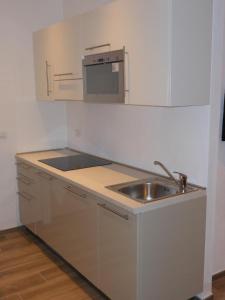 a small kitchen with a sink and a microwave at Residence Fanny in Alassio +74 photos