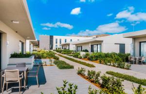 a courtyard with tables and chairs in a building at Vila Baleira Village in Porto Santo