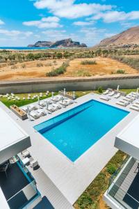 an aerial view of a swimming pool with lounge chairs and a swimming pool at Vila Baleira Village in Porto Santo