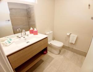a bathroom with a white sink and a toilet at Higgins Lane Motel in Margaret River Town +12 photos