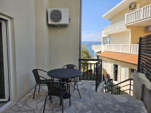 a patio with a table and chairs on a balcony at Apartmani Katja in Omiš