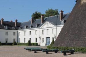 a large white building with cannons in front of it at ibis budget Montceau les Mines in Montceau-les-Mines