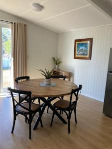 a dining room with a wooden table and chairs at 40 On North. in Wandoan +17 photos