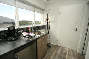 A kitchen or kitchenette at Skýjaborg Apartments