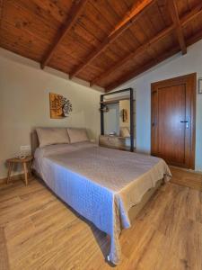 a bedroom with a bed and a wooden floor at Vista Mare in Kámpos +13 photos