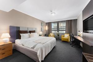 a bedroom with a bed and a desk and a television at 1 Valentine Ave in Sydney +20 photos