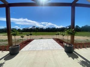 a patio with two potted trees in pots at Cottonvale Country Lodge 
