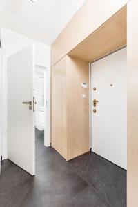 an empty room with a door and a hallway at Apartment Zegadłowicza in Kraków
