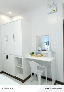 a white kitchen with a white desk and a chair at EPM Tower Hotel and Events Place in Alfonso +87 photos