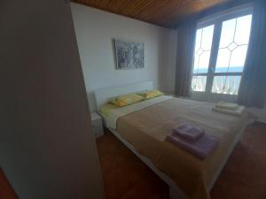 a bedroom with a bed with two towels on it at Apartments & Rooms Villa Anastasija in Ulcinj