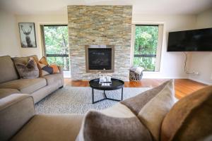 a living room with a couch and a fireplace at Alpine Nest in Bright