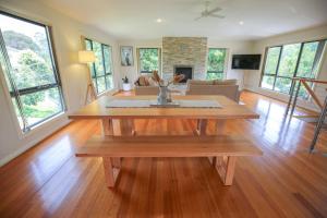 a living room with a wooden table and a couch at Alpine Nest in Bright +21 photos