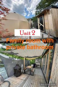 a family room with a picnic table on a deck at Fuji Dome Glamping in Fujikawaguchiko