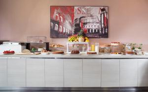 a buffet with food on a counter in a room at Club Meeting Hotel in Rimini