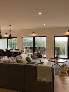 a living room with a couch and a table at Spa & Pure Relaxation - Chalet Saint-Cerf in Saint Come