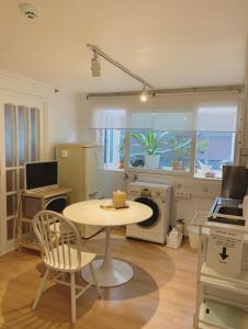 a kitchen with a table and a table and chairs at liilliil Residence Seoul in Seoul