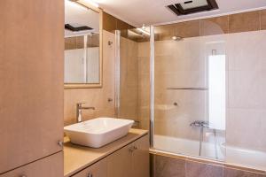 a bathroom with a sink and a shower at Gina's house in Asklipiḯon +42 photos