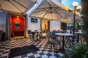a restaurant with tables and chairs and umbrellas at Park Plaza Bonaparte Boutique in Santiago +44 photos