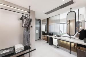 a bathroom with a vanity and a mirror at KSpace KaiShi hotel in Guangzhou