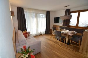 a living room with a couch and a dining room at Villa Paröis in La Valle